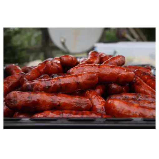 several chorizo cooked on a barbecue