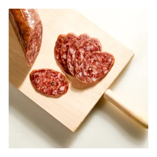 Domiciano Garcia spicy sausage (salchichón) partially sliced on a chopping board