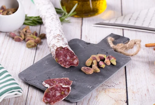 El pozo spicy catalan sausage (fuet) partially sliced on a charcuterie board