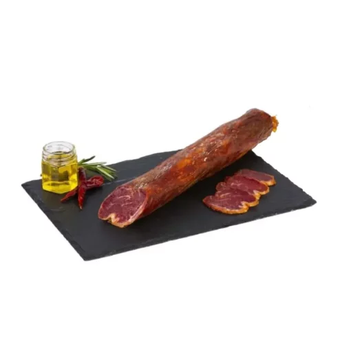 iberian pork tenderloin sliced and unsliced on a slate with olive oil
