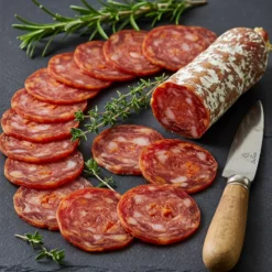 Iberian chorizo exra from prado bellow partially sliced on a board