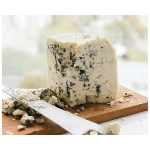 A small block of cabrales asturiano cheese on board with knife