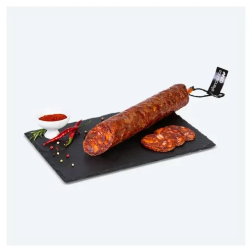 premium quality iberian chorizo whole and sliced on a plate with tomato paste
