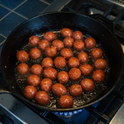 Palcarsa mini chorizos frying on pan