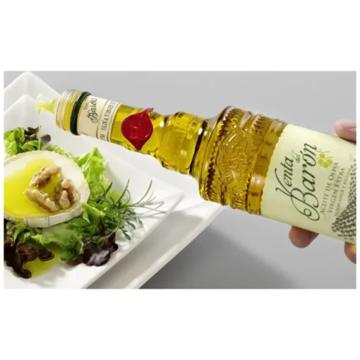 Venta de Barón extra virgin olive oil poured on salad