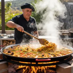 Man cooking a large paella